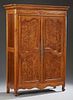 Louis XV Style Carved Cherry Armoire, early 19th c., the rounded edge ogee crown double fielded panel burled elm doors, on ca
