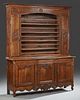 French Louis XV Style Carved Oak Vaisselier, 19th c., the stepped crown over central plate rails flanked by cupboard doors, s