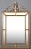 Classical Style Florentine Gilt Wood Overmantle Cushion Mirror, 20th c., with an urn surmount flanked by scrolling gilt iron 