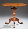 English Carved Mahogany Tilt Top Table, 19th c., the circular top and turned baluster support, with tripodal cabriole legs to