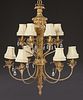 French Style Louis XVI Gilt Iron and Composition Twelve Light Chandelier, 20th c., with a relief leaf mounted torch form supp