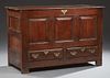 French Carved Oak Coffer, 19th c., the lifting lid storage area over a paneled case with two lower drawers, on block feet, H.