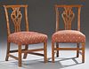 Pair of English Chippendale Style Carved Oak Side Chairs, 19th c., the serpentine crest rail over a pierced carved vertical s