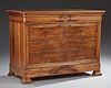 French Louis Philippe Carved Walnut Commode, c. 1860, the rounded corner rectangular top over a cavetto frieze drawer and thr