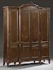 Large French Louis XV Style Carved Walnut Armoire, 19th c., the pierced ribbon crest on an arched crown over a large center d