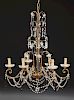 French Gilt Iron Six Light Chandelier, 20th c., hung with clear prisms, prism chains and black tear drop prisms, the six scro