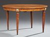 French Ormolu Mounted Inlaid Carved Walnut Dining Table, 20th c., the circular top opening to accept leaves over a wide skirt