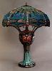 Tiffany Style Leaded Slag Glass Dragonfly Lamp, 20th c., the scalloped circular shade with dragonfly figures and blue cabocho