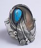 Man's Native American Bear Claw Sterling Ring, 20th c., the top with relief leaf designs and a turquoise nugget, size 12 1/2.