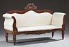 American Classical Carved Mahogany Sofa, 19th c., the serpentine back with a central scroll and floral crest, over an upholst