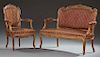Two Piece French Louis XV Style Carved Walnut Parlor Suite, early 20th c., consisting of a settee and a fauteuil, the arched 