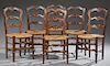 Set of Six French Provincial Carved Oak Side Chairs, late 19th c., the arched shell carved ladder backs over rush seats, on r