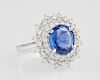 Lady's Platinum Dinner Ring, with an oval 3.13 carat blue sapphire, atop a double concentric graduated border of round diamon