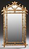 Carved Gilt Wood Overmantle Mirror, 20th c., the pierced double branch form frame with relief carved floral, grape and leaf d