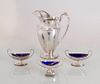 SILVER PLATE WATER PITCHER AND THREE SILVER PLATE SALT CELLARS WITH BLUE GLASS LINERS