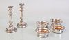 SET OF FOUR ENGLISH SILVER PLATE BOTTLE COASTERS AND A PAIR OF CANDLESTICKS