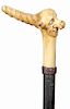189. Whimsical Stag Cane- Ca. 1890- A carved antler with a whimsical carving with a gentlemen with a long nose and two color glass eyes, braided leath