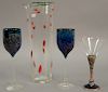 Four piece art glass group to include Berebi enameled stemmed martini glass, two art glass wine stems, and an art glass pitcher sign...