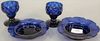 Pair of cobalt blue quilted hand blown stem glasses (possibly sandwich glass), and a pair of cobalt blue flower form saucers with sc...