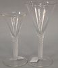 Group of twelve blown crystal flutes with air twist stems in two sizes. (5) height 6 1/2 inches, (7) height 8 inches 

Provenance: E...