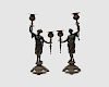 Pair of Continental Patinated Bronze Figural Two Light Candlesticks, with gilt highlights