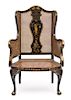 A Regency Style Black and Gilt Chinoiserie Decorated Caned Wing Chair Height 50 inches.
