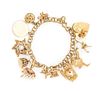 A 14 Karat Yellow Gold Charm Bracelet with 13 Attached Charms, 26.00 dwts.
