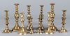 Five pairs of brass candlesticks
