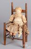 Antique composition doll and doll chair.