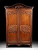 A FRENCH PROVINCIAL CARVED WAXED PINE ARMOIRE, FIRST HALF 19TH CENTURY,