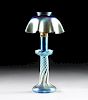 A TIFFANY STUDIOS BLUE FAVRILE GLASS CANDLESTICK LAMP, ENGRAVED "L.C.T.' AND "Favrile," CIRCA 1910,