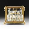A FRENCH TWENTY-TWO PIECE GILT BRONZE AND GLASS TANTALUS SET, LATE 19TH/EARLY 20TH CENTURY,