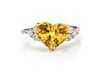 A Platinum, 18 Karat Yellow Gold, Yellow Sapphire and Diamond Ring, 1.80 dwts.