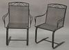 Eight piece outdoor iron set to include a set of six spring armchairs and two small tables.
