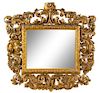 * An Italian Baroque Style Giltwood Mirror Height 51 x width 52 inches.