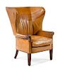 A George III Style Leather-Upholstered Wingback Chair Height 45 1/4 x width 32 3/4 x depth 35 inches.
