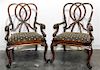 A Pair of Walnut Open Arm Chairs Height 42 inches.