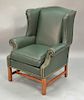 Ethan Allen green leather upholstered wing chair.
