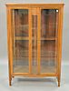 Oak two door China cabinet with glass shelves. ht. 59 1/2in., wd. 39in.