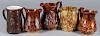 Five molded pottery pitchers