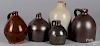 Five redware and stoneware jugs