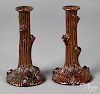 Pair of redware tree trunk candlesticks