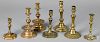 Seven brass and bell metal candlesticks