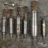 Seven pewter enema syringes