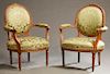 Pair of French Louis XVI Style Upholstered Beech Fauteuils, early 20th c., the medallion backs flanked by upholstered arms, to bowed seats, on turned 