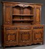 French Provincial Louis XV Stle Carved Cherry Buffet a Deux Corps, 20th c., the stepped crown over two central setback plate racks flanked by fielded 