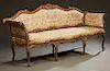 French Louis XV Style Carved Walnut Settee, 19th c., the serpentine crestrail over an upholstered back and bowed seat flanked by scrolled upholstered 