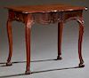 French Louis XV Style Carved Walnut Table, 19th c., the stepped serpentine top over a paneled serpentine skirt, on carved splayed legs and claw and ba