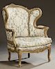French Polychromed Louis XV Style Bergere, 19th c., the arched carved crest over an upholstered back and arms above a loose seat cushion, on cabriole 