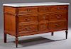French Louis XVI Style Carved Mahogany Marble Top Dresser, early 20th c., the figured white cookie cornered ogee edge marble top over a central bank o